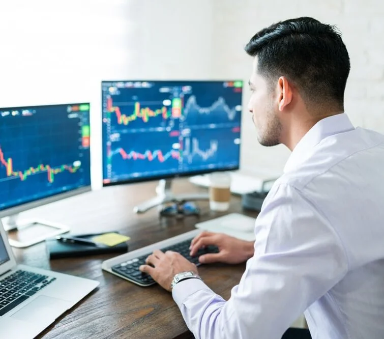 A man at a computer studies graphs